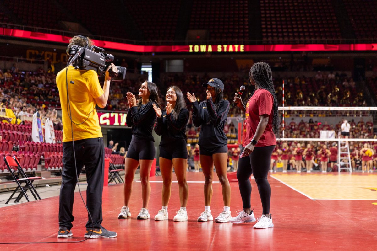 Head gymnastics coach, Ashley Miles Greig (right), introduces members of the Iowa State gymnastics program during a break in the Iowa State vs. Kansas State game. Hilton Coliseum, Ames, Iowa, Aug. 23, 2025.