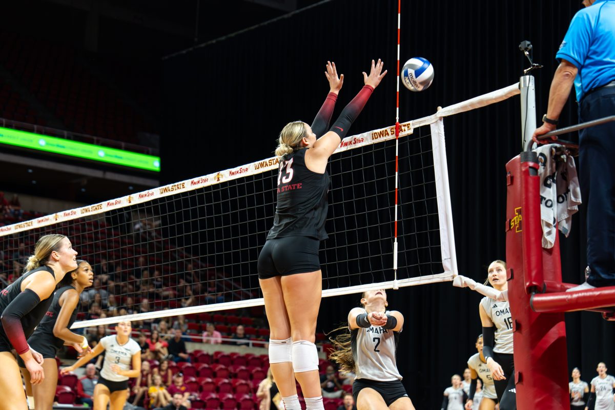 Lilly Wachholz (13) blocking the ball during the Iowa State vs. Omaha volleyball game at Hilton Coliseum in Ames, Iowa, Sept. 14, 2025.