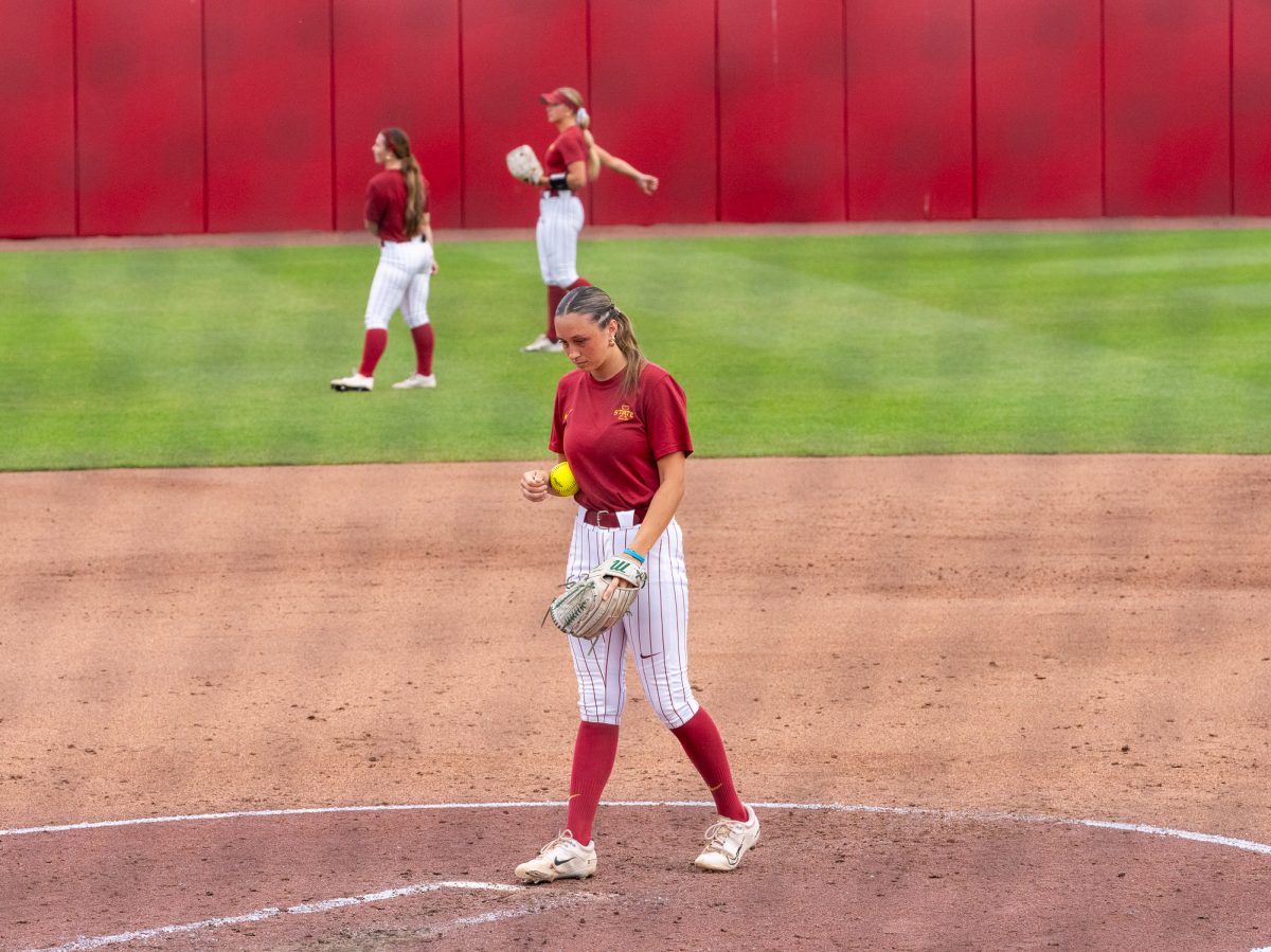 Ava Mulllen (4) prepares to pitch, Iowa State Infeilder feilds a hit and throws for an out at first, Sept. 21, Iowa State Sports Complex, Ames, Iowa