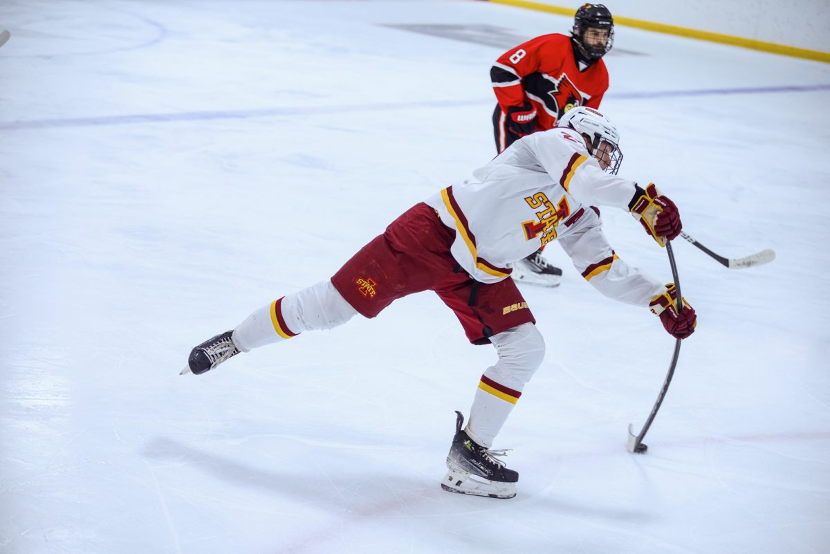 Dylan Hender (27) shooting a puck, Ames Ice Arena, Ames, Iowa, Jan. 17, 2026.