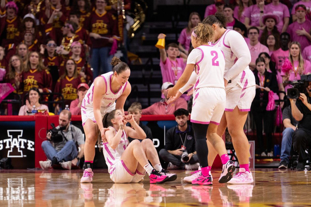 Reese Beaty (1) helping up Kenzie Hare (12) after she was thrown to the ground. Iowa State vs. Kansas State. Hilton Coliseum, Ames, Iowa, Feb. 15, 2026.