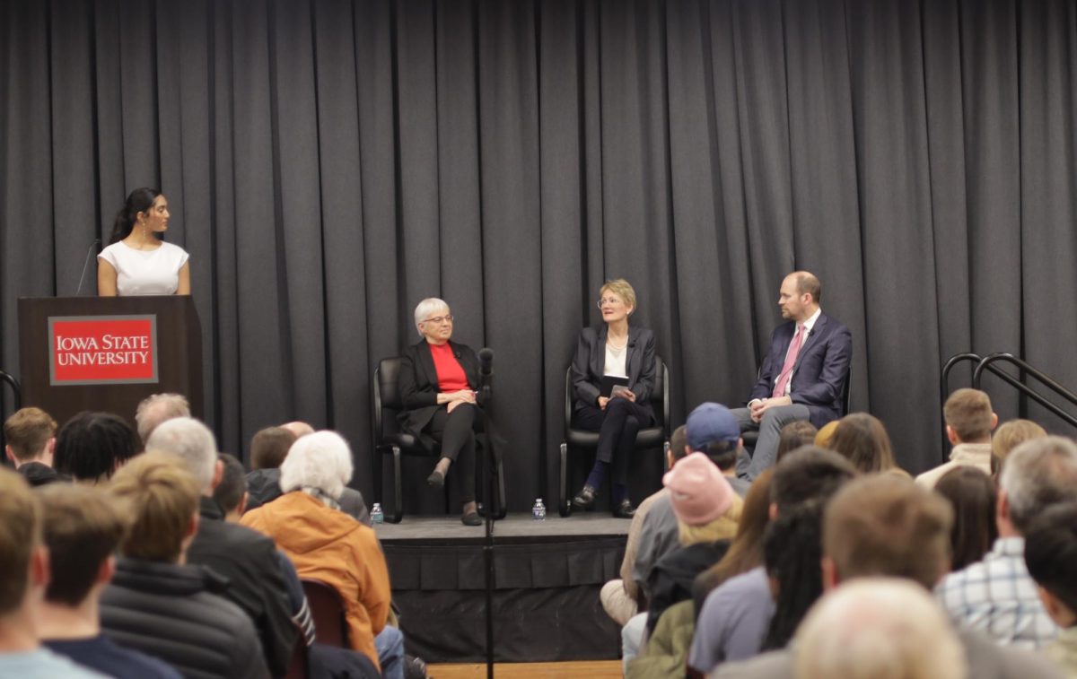 Genevieve Signoret (middle) answers a question about U.S. economic policy as Katharine Abraham (left) and Benjamin Malin (right) look on in the Sun Room of the Memorial Union, Ames, Iowa, Feb. 5, 2026.

