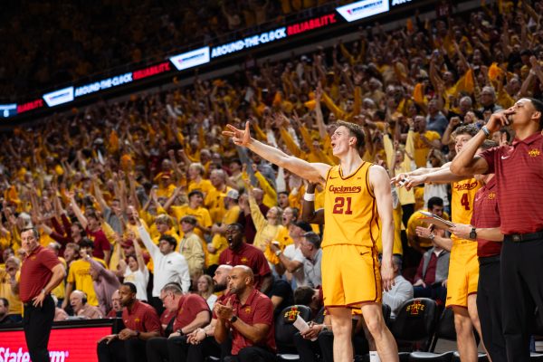 Dominykas Pleta (21) celebrates a teammates three-pointer during the Iowa State men’s basketball victory over Houston, 70-67, at Hilton Coliseum in Ames, Iowa, on Feb. 16, 2026.