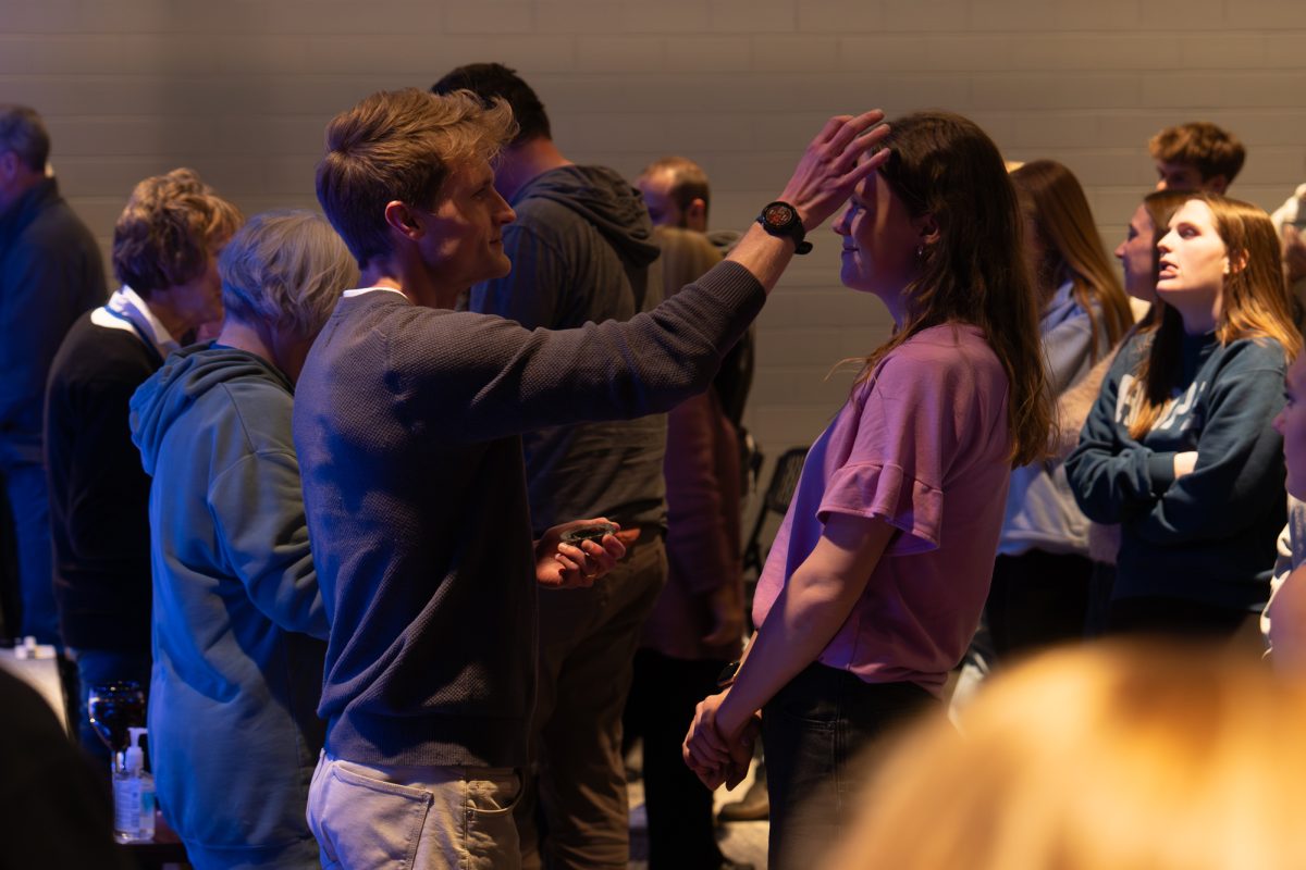 Paster Danny Housholder applies an ash cross on a congregant's forehead at Hope Ames, Ames, Iowa, Feb. 18, 2026. 