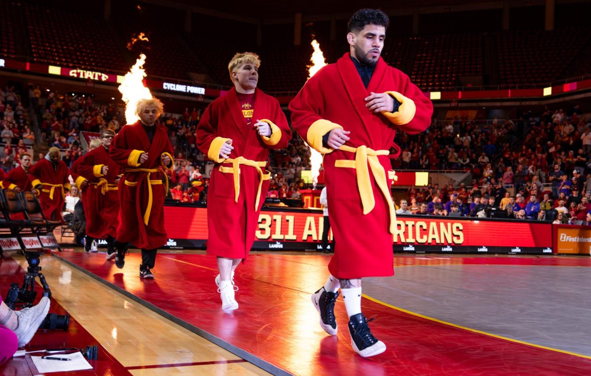 Anthony Echemendia and Jacob Frost run out prior to the dual against the University of Northern Iowa inside Hilton Coliseum in Ames, Iowa, Feb. 15, 2026.