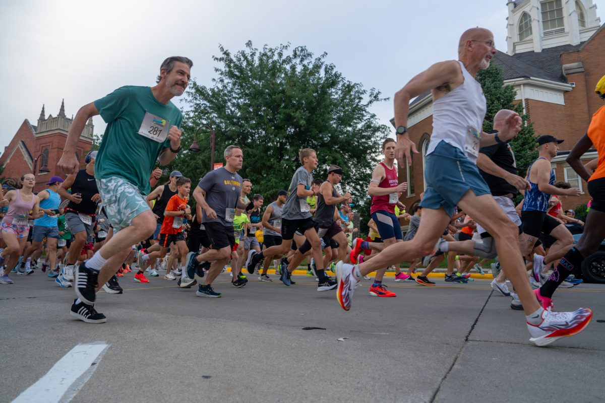 Marathoners run the 55th Midnight Madness in Downtown Ames, Iowa, July 10, 2026.