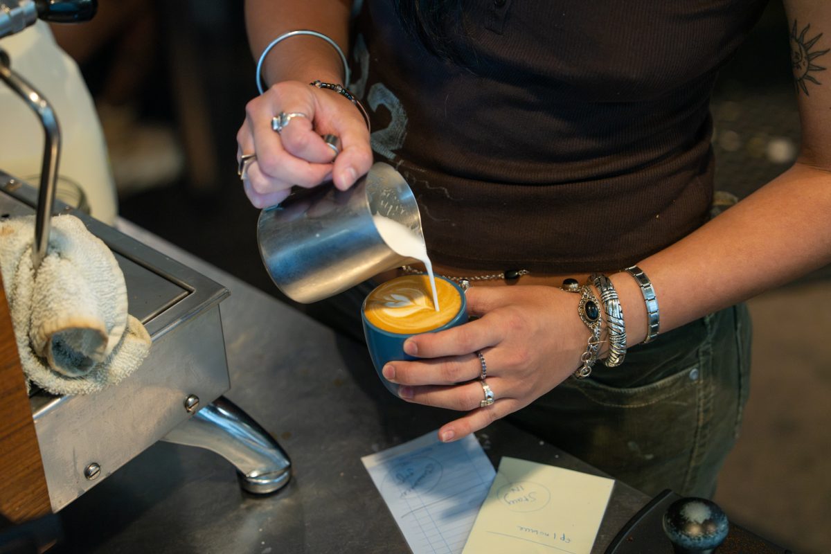 A barista with Lockwood Cafe creates foam art on a drink order at their location in Ames, Iowa, July 11, 2026.