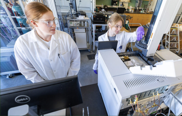 Mechanical engineering doctoral students Sarah Tyree and Madeleine McMahon use a new gas chromatography machine in a lab in the Biorenewables Complex. A strategic plan award last year purchased several pieces of equipment that will expand research capabilities at the Bioeconomy Institute. Photo by Christopher Gannon.