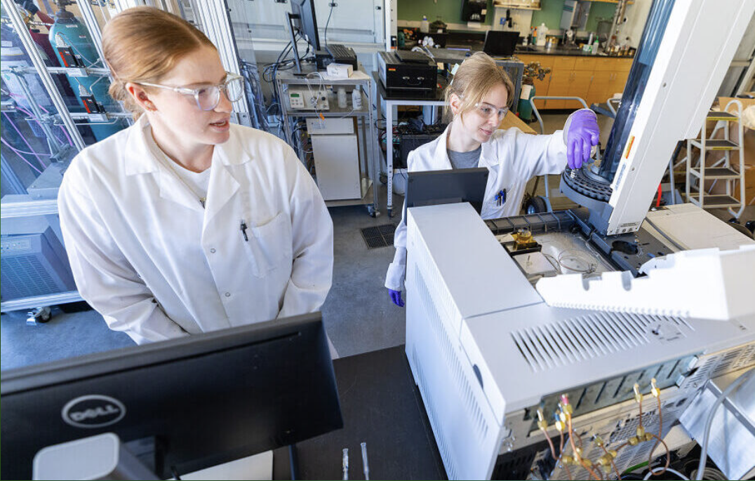 Mechanical engineering doctoral students Sarah Tyree and Madeleine McMahon use a new gas chromatography machine in a lab in the Biorenewables Complex. A strategic plan award last year purchased several pieces of equipment that will expand research capabilities at the Bioeconomy Institute. Photo by Christopher Gannon.