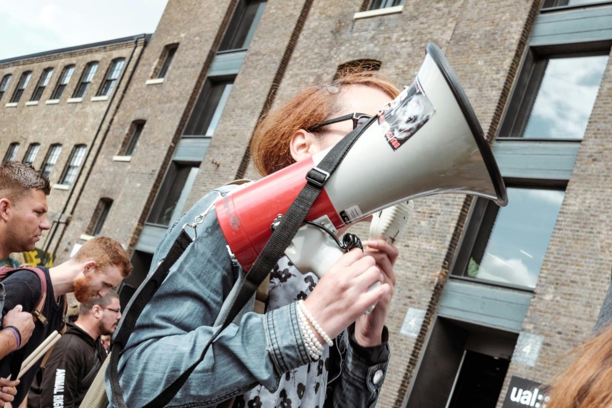 Woman protesting. Courtesy of Unsplash.